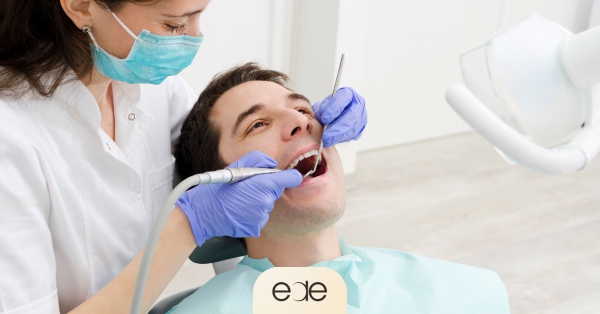 Dentist examining a patient’s teeth during an appointment before discussing the next steps in care.