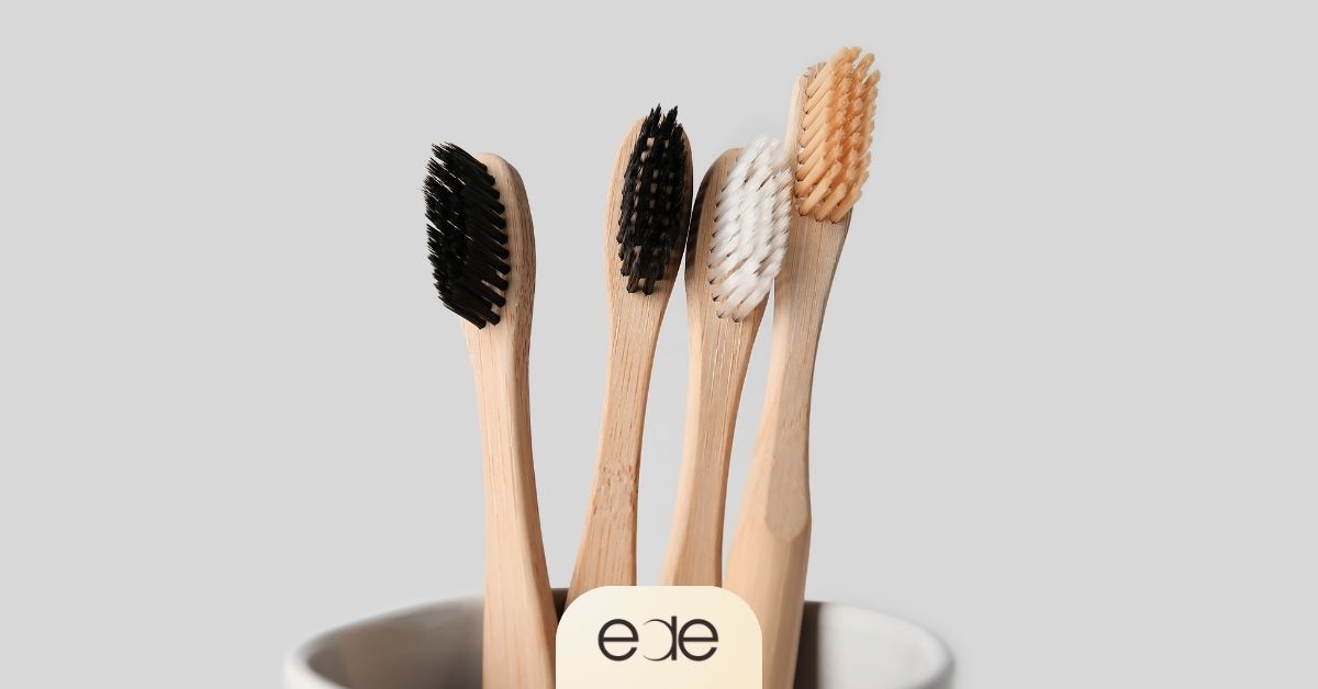 Toothbrushes in a cup illustrating oral hygiene tools for caring for gums around dental implants.