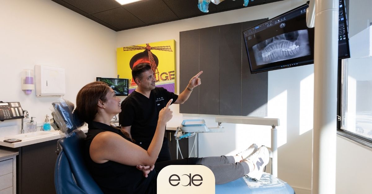 Dentist discussing dental X-rays and treatment options with a patient in Encino.