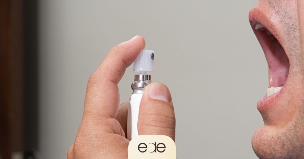 Person using mouth spray to freshen breath instantly