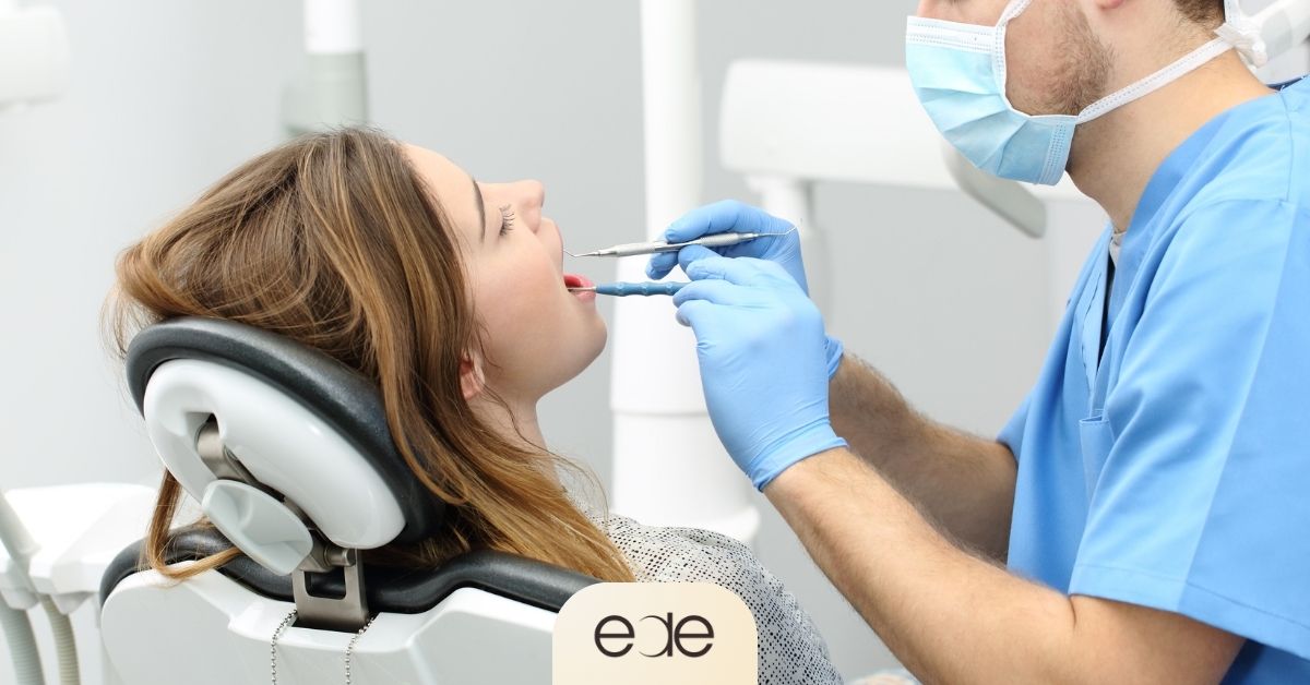 Dentist examining a patient’s tooth before root canal treatment, illustrating the initial evaluation and preparation stage of the procedure.