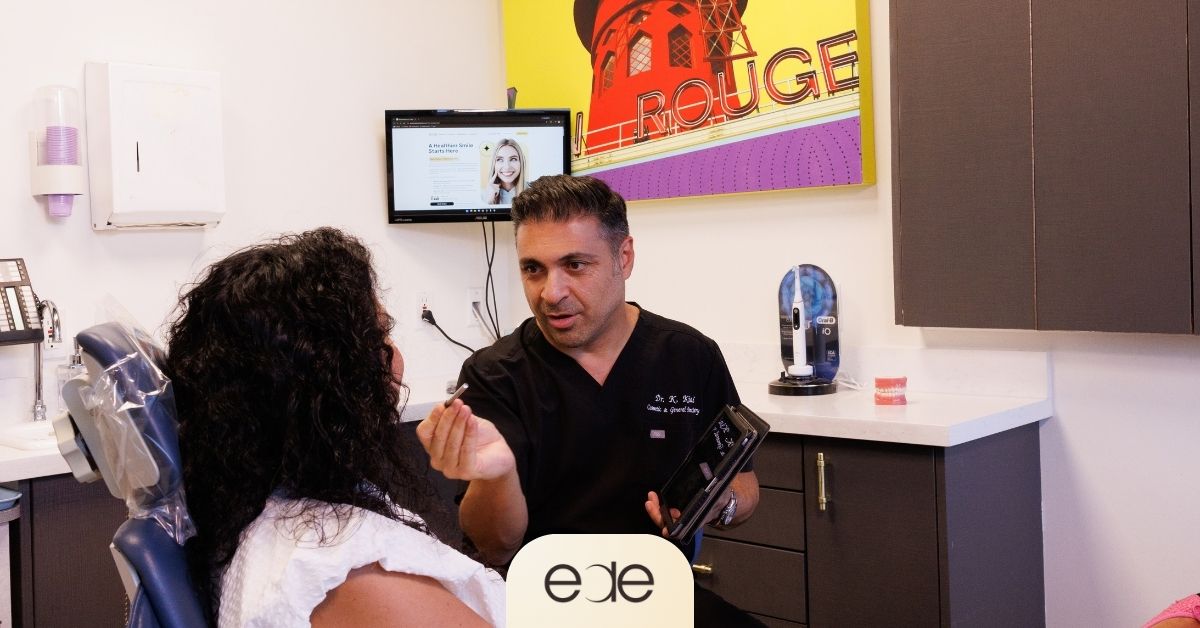 Dentist discussing symptoms and follow-up care with a patient experiencing pain after a filling.